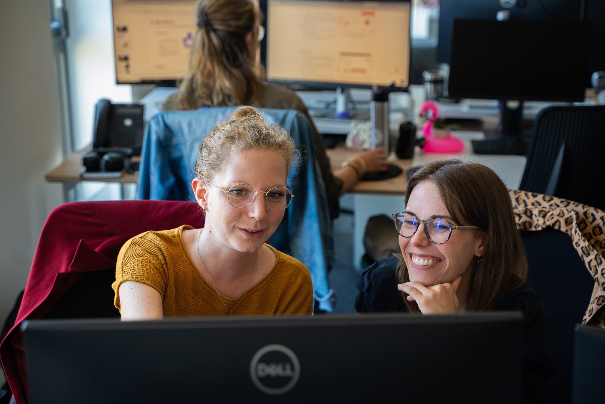 Deux collaboratrices travaillent sur un même projet dans les bureaux de l'agence Winbound
